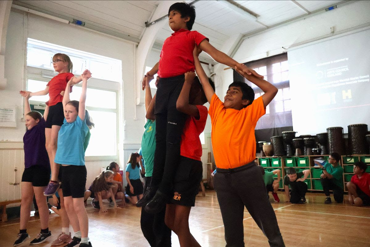 children in colourful t-shirts take part in a Motionhouse workshop